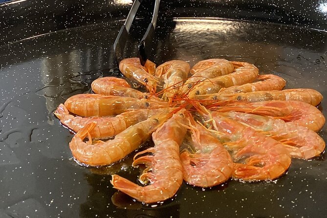 Barcelona: Black Ink Seafood Paella Cooking Class - Cooking the black seafood paella