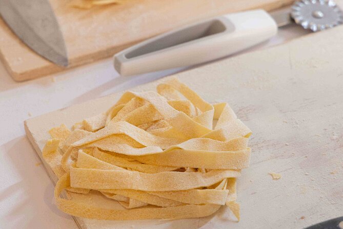 Fettuccine Ravioli and Tiramisu Cooking Class in Rome - Rolling Dough Into Fettuccine
