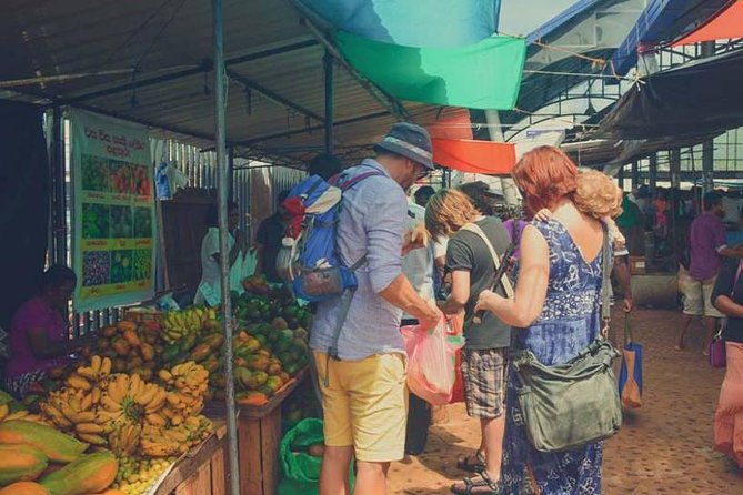 Local Market Tour & Cooking Demo with Lunch from Colombo Harbor - Choosing vegetables and fruit at a local market