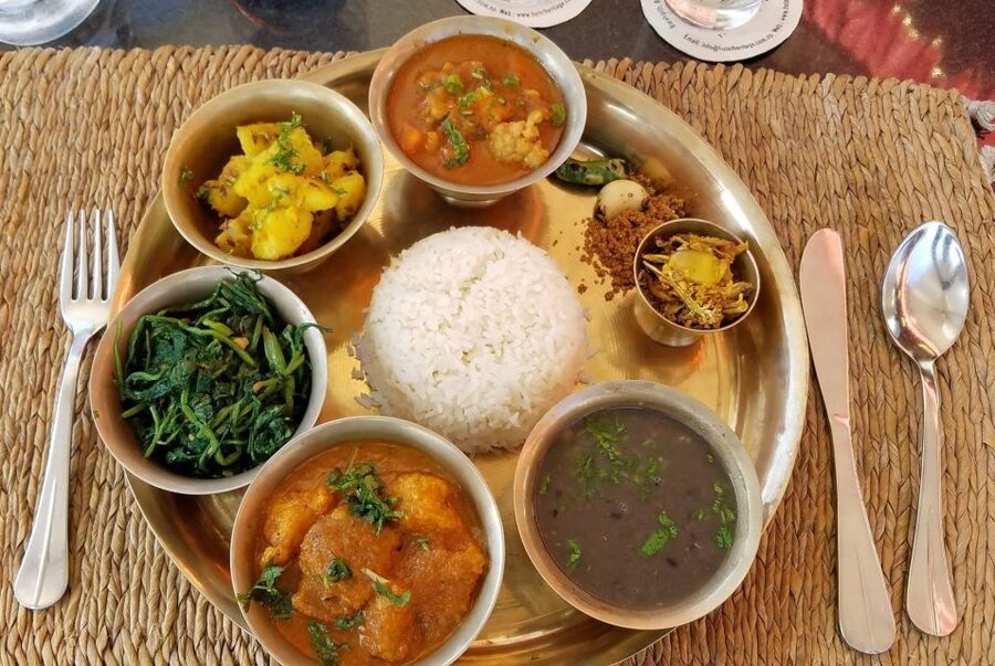 MoMo or Dal Bhat Cooking Class at Aama Kitchen in Pokhara - Working beside the family head