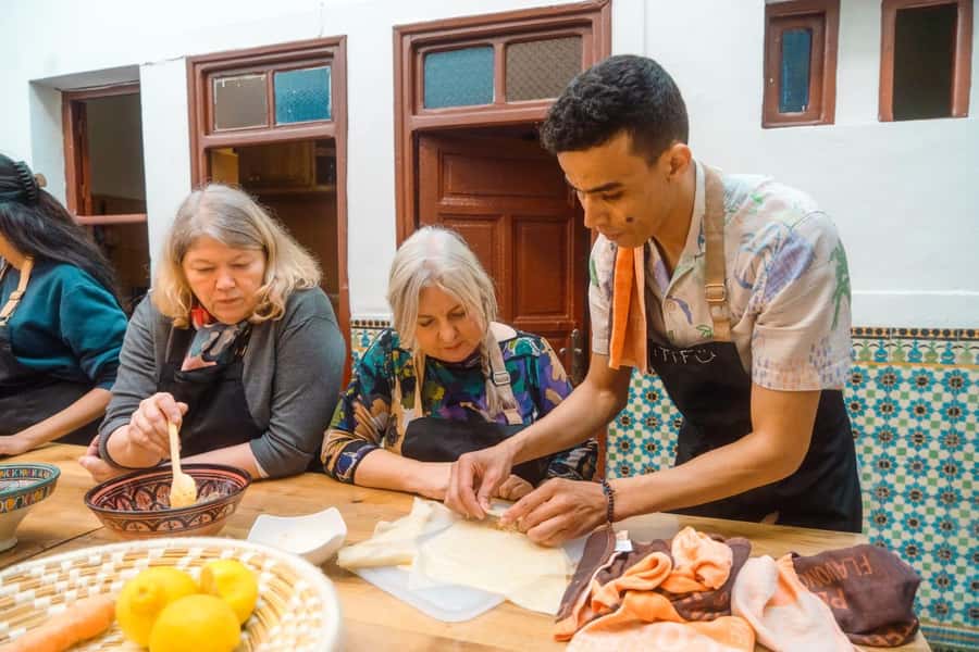 Moroccan Food Cooking Class with a Local Chef in Marrakech - Sitting down to eat what you made