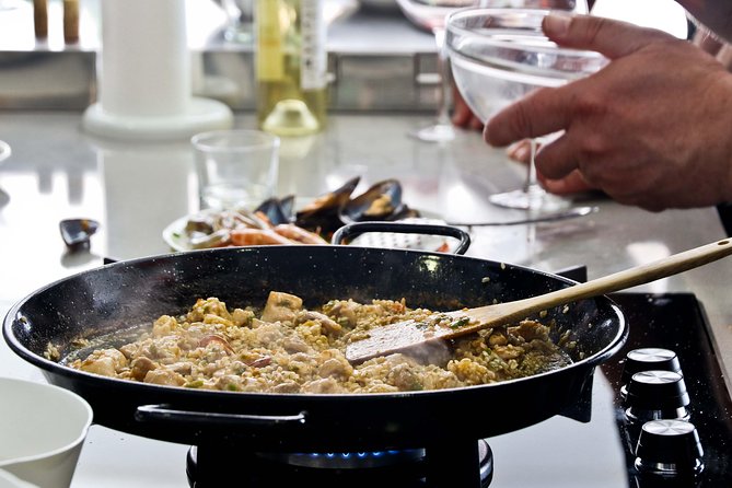 Paella Cooking Class in Malaga - Olive oil, olives, almonds, and Malaga on a plate