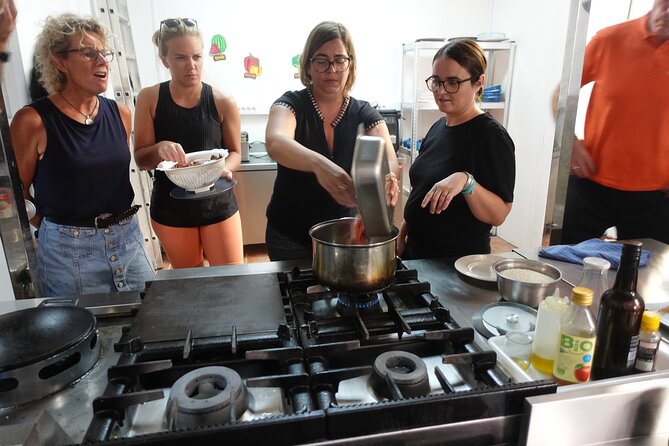 Paella & Sangria Class with Tapas and Market Visit - Building paella from stock to rice