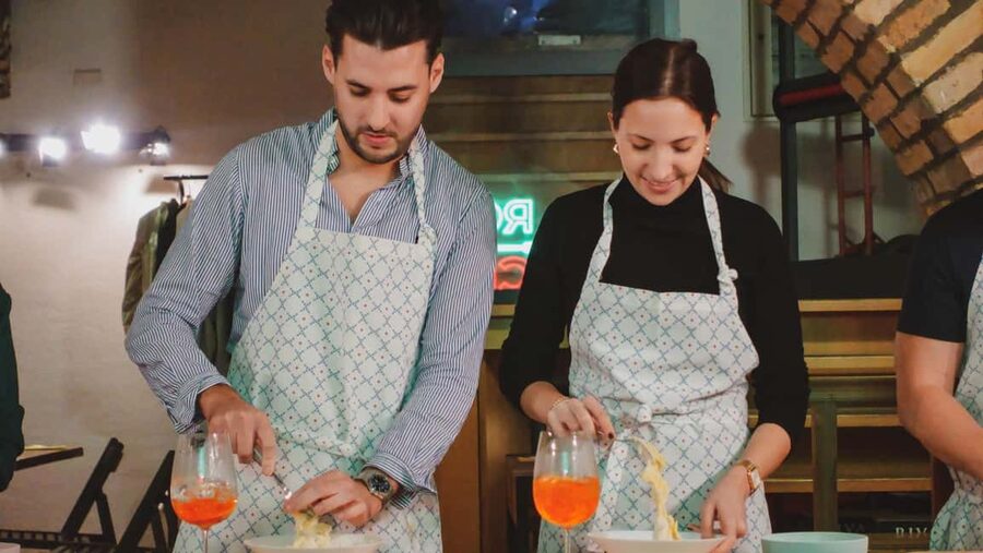 Rome: Spritz & Spaghetti Cooking Class - Sitting down to eat your finished pasta