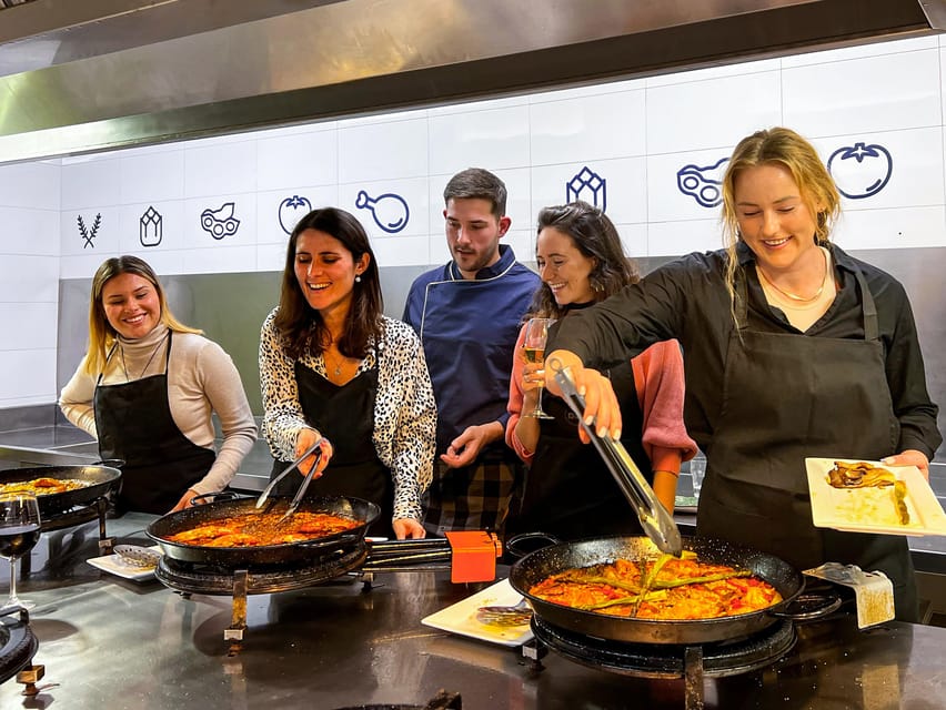 Valencia: Paella Cooking Class with Central Market Tour - Sitting down to eat what you cooked